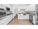 Modern kitchen featuring stainless steel appliances, farmhouse sink, and white cabinets at 716 W Graham St, Shelby, NC 28150