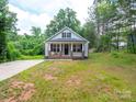 Charming home featuring a brick-lined front porch and beautifully maintained landscaping at 720 4Th St, Stanley, NC 28164