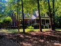 Charming brick two-story home with covered front porch, mature trees and manicured lawn at 7408 Mockingbird Ln, Waxhaw, NC 28173