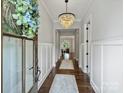 Bright foyer with hardwood floors, chandelier, and view into the living spaces at 822 River Oaks Ln, Charlotte, NC 28226