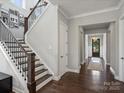 Beautiful staircase and entryway featuring hardwood floors and iron railing at 822 River Oaks Ln, Charlotte, NC 28226