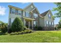 Attractive home with gray siding, stone features, and a lush green lawn at 8427 Penton Pl, Harrisburg, NC 28075