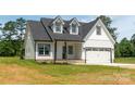 Charming two-story home featuring a two-car garage and well-maintained front lawn at 1010 Oneil Dr, Monroe, NC 28112