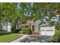 View of the home's exterior showcasing the garage and landscaped yard at 10121 Edgecliff Rd, Huntersville, NC 28078