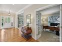 Inviting foyer featuring hardwood floors and an elegant chest at 10121 Edgecliff Rd, Huntersville, NC 28078