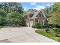 Brick home with a two-car garage and well-maintained landscaping and a long concrete driveway at 1069 Westlake Dr, Kannapolis, NC 28081