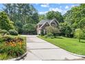 Beautifully landscaped front yard with mature trees and a long driveway leading to a classic brick home at 1069 Westlake Dr, Kannapolis, NC 28081
