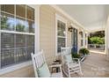Cozy front porch featuring rocking chairs, creating a relaxing outdoor space at 11806 Stirling Field Dr, Pineville, NC 28134
