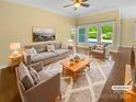 Bright living room with large windows and plush seating arrangement at 13419 Morgan Lee Ave, Charlotte, NC 28213