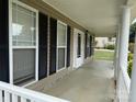 Inviting front porch featuring black shutters and decorative columns at 156 Tarrington Dr, Statesville, NC 28625