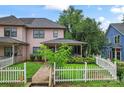 Charming two-story home featuring a white picket fence, a covered front porch, and nice landscaping at 1609 Begonia Way, Rock Hill, SC 29732