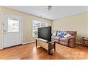 Bright living room featuring hardwood floors, a large window, and a comfortable couch at 1609 Begonia Way, Rock Hill, SC 29732