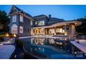 Luxury home featuring outdoor pool and hot tub with elegant stone accents and evening ambiance at 175 Rehoboth Ln, Mooresville, NC 28117
