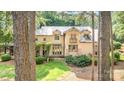 A beautiful exterior view with a stone pathway and verdant lawn framed by trees at 177 Yadkin Falls Rd, New London, NC 28127