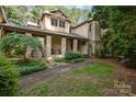 An inviting front entrance with stone columns, a brick path, and manicured landscaping at 177 Yadkin Falls Rd, New London, NC 28127