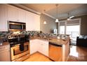 Modern kitchen featuring stainless steel appliances, granite countertops, open to the living area at 230 S Tryon St # 304, Charlotte, NC 28202