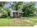 Attractive home featuring a covered front porch and well-manicured lawn at 2312 Tate St, Charlotte, NC 28216