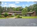 Beautiful exterior view of modern home with manicured lawn and mature trees during daytime at 307 E Allenton St, Mount Gilead, NC 27306
