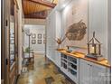 Charming hallway with stone floors, wood ceiling, and decorative art at 307 E Allenton St, Mount Gilead, NC 27306