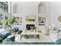 Bright living room with high ceilings, built-in bookshelves, fireplace, and stylish furniture at 3996 Channel Point Ln, Denver, NC 28037