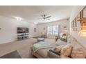 Bright living room with a large sectional couch, ceiling fan, and natural light at 4113 Bent Green Ln, Monroe, NC 28112