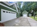 Spacious three-car garage with a well-maintained driveway and additional storage shed at 458 Leaf Arbor Ct, Clover, SC 29710