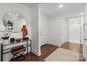 Bright hallway with stylish mirror, decor, and wood floors welcomes you into the condo at 4625 Piedmont Row Dr # 712, Charlotte, NC 28210
