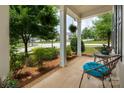Spacious front porch with ample seating and lush greenery, creating a warm and welcoming entrance to the home at 5042 Alston Dr, Lancaster, SC 29720
