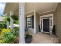 Inviting front porch with classic columns and seating area, perfect for relaxing and enjoying the neighborhood views at 5042 Alston Dr, Lancaster, SC 29720