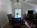 Dining area with a wooden table, six chairs, and large windows allowing natural light at 6007 Crosswood Ct, Charlotte, NC 28215