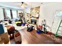 Living room features a stone fireplace, hardwood floors, and a ceiling fan at 6007 Crosswood Ct, Charlotte, NC 28215