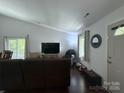 Bright living room with hardwood floors, large window, and comfortable seating arrangement at 6007 Crosswood Ct, Charlotte, NC 28215
