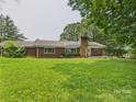 Lovely brick ranch featuring a well-manicured lawn, chimney, and inviting front entrance at 61 23Rd Nw St, Hickory, NC 28601