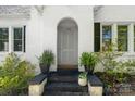 Close-up of the front door with plants on the stoop, showcasing the house number and white brick facade at 772 Eden Ter, Rock Hill, SC 29730