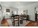 Inviting living room with hardwood floors, neutral walls, a decorative rug and an elegant light fixture at 772 Eden Ter, Rock Hill, SC 29730