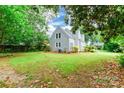 Spacious backyard with green lawn, trees, and rear view of home's exterior at 904 Venus St, Kannapolis, NC 28083