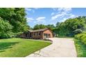 Sprawling home featuring a long driveway, attached garage, and a well-manicured lawn, perfect for outdoor enjoyment at 9410 Mountain Aire Cir, Charlotte, NC 28214
