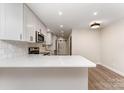 Bright, updated kitchen with white cabinets, quartz countertops, stainless appliances and modern light fixtures at 9410 Mountain Aire Cir, Charlotte, NC 28214