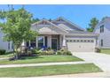 Inviting home with a lush front yard, charming porch, and an attached garage, perfect for a Gathering at 9541 Festival Way, Charlotte, NC 28215