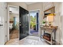 Welcoming entryway with tiled floor, decorative table, and view to bedroom and outdoor landscape at 1007 Southwest Dr, Davidson, NC 28036