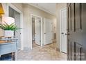 Bright hallway showcasing neutral color palette, tiled floor, and access to rooms at 1007 Southwest Dr, Davidson, NC 28036