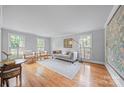 Spacious living room featuring hardwood floors, neutral colors, and ample natural light at 10918 Megwood Dr, Charlotte, NC 28277