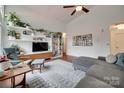 Cozy living room featuring a ceiling fan, modern furnishings, and stylish decor at 11615 Chadburn Ln, Charlotte, NC 28215