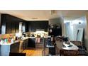 View of an eat-in kitchen with black cabinets and stainless steel appliances at 1250 Landsdowne Dr, Conover, NC 28613