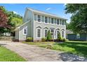 Attractive two-story home with large windows, landscaping, and a well-maintained front lawn at 13010 Indian Hills Ln, Charlotte, NC 28278