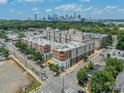 Wide aerial view showing the stylish brick apartment complex in Dilworth and the Charlotte skyline at 1315 East Blvd # 327, Charlotte, NC 28203