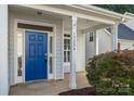 Welcoming front entrance with a bright blue door and sidelights, creating curb appeal at 15280 Leslie Brook Rd, Huntersville, NC 28078