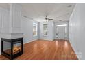 Bright living room with hardwood floors, a modern fireplace, and natural light at 15280 Leslie Brook Rd, Huntersville, NC 28078