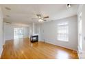 Bright living room with hardwood floors, fireplace, and sliding doors to the sunroom at 15280 Leslie Brook Rd, Huntersville, NC 28078
