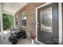 Inviting front porch featuring decorative accents and a cozy seating area near a decorative front door at 15636 Oleander Dr, Charlotte, NC 28278